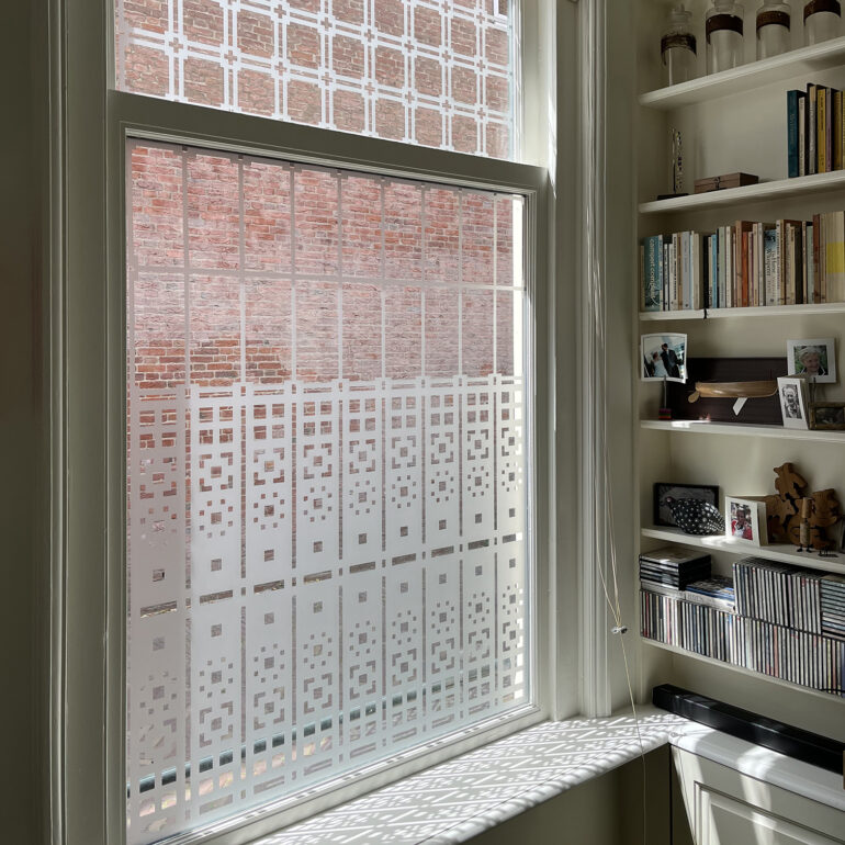 folie van een Schutspatroon op woonkamerramen van binnenuit gezien